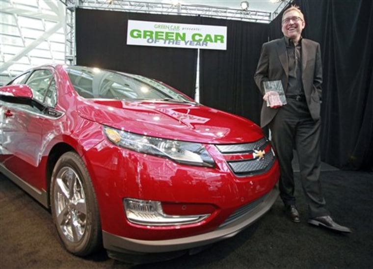 Joel Ewanick, General Motors Co. vice president for U.S. Marketing, holds the award won by the Chevy Volt as 2011 Green Car of the Year.